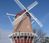 A windmill with a clear blue sky in the background.