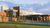 A wide view of the main campus entrance from outside.